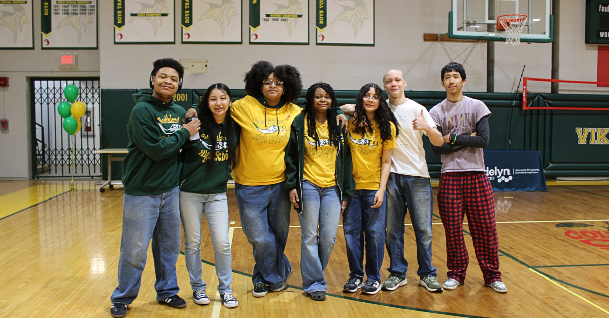 group of students wearing yellow shirts inside gymnasium